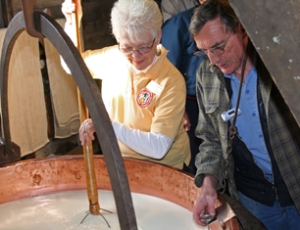 Heating the curds in traditional copper kettles